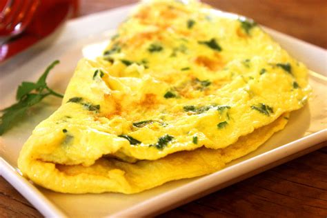 Combine eggs, salt, cayenne, parsley, marjoram, thyme, and white Cheddar cheese in a small bowl and beat with a fork until combined. Heat oil in a small, nonstick pan over medium heat. Pour the egg mixture into the hot pan and use a rubber spatula to begin scrambling the eggs, moving constantly and scraping the sides of the pan as needed.